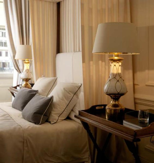 White ceramic hotel-style table lamp with copper detail