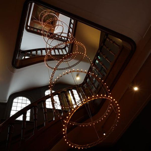 Studded LED ring  pendant for single or modular use in a modern stairwell