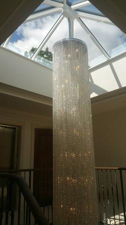 Specially-commissioned 8 metre-tall stairwell chandelier with sparkling crystals