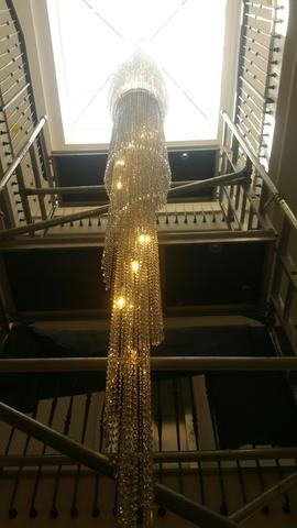 Specially-commissioned 8 metre-tall stairwell chandelier with sparkling crystals